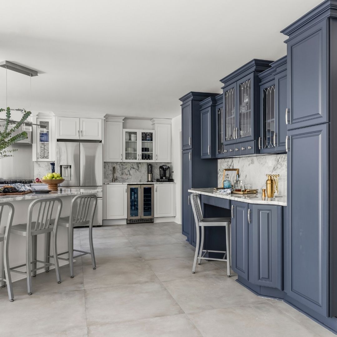 Modern kitchen featuring blue cabinetry, white countertops, and kitchen island seating