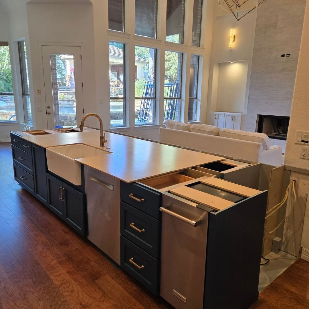 Open-concept kitchen featuring long island with built-in dishwasher and cabinetry