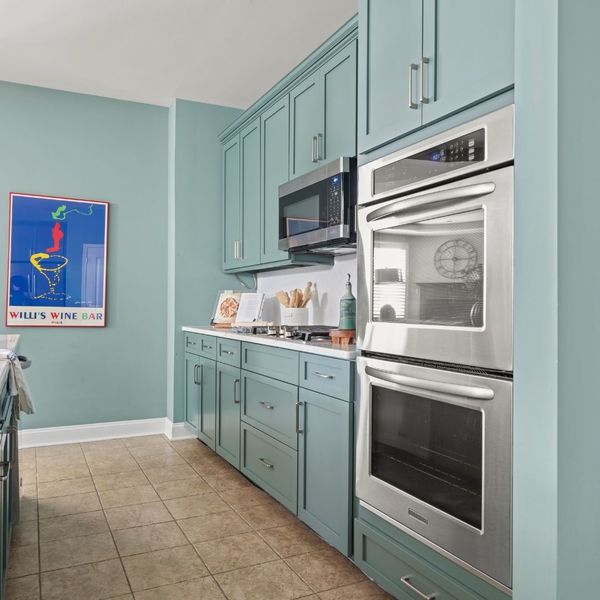 remodeled kitchen with green cabinets