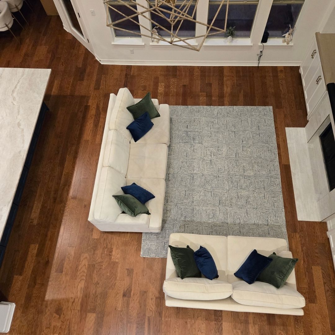 Aerial top-down view of a living room layout with sofas and area rug