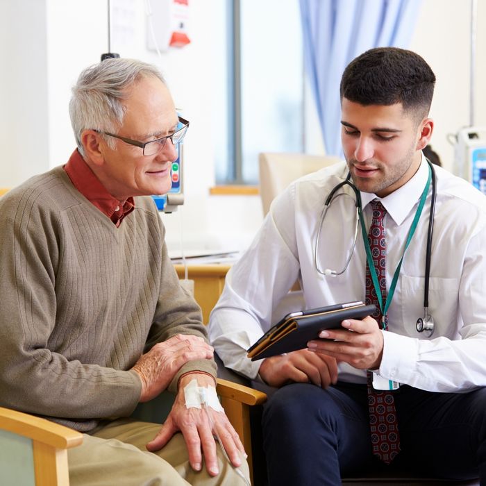 Doctor showing patient information on a tablet