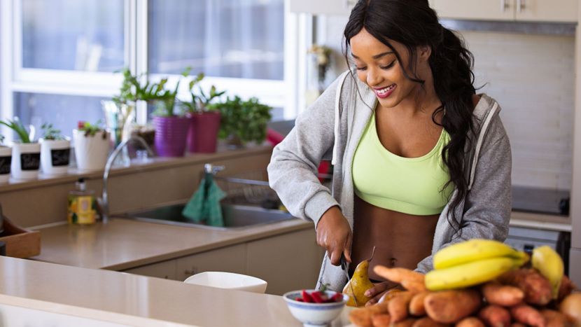 Healthy woman cutting fruit.