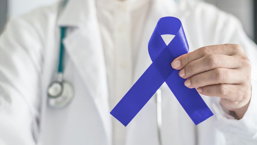 a doctor holding a blue ribbon