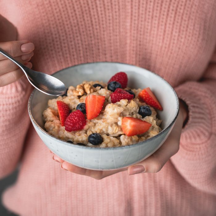 Woman eating a bowl of oatmeal