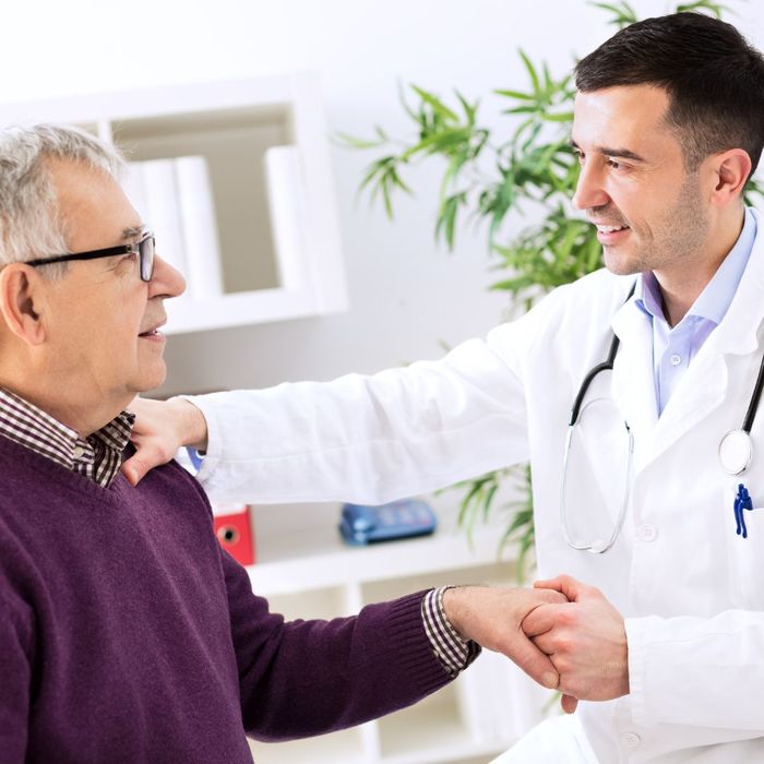An older man speaking with a doctor
