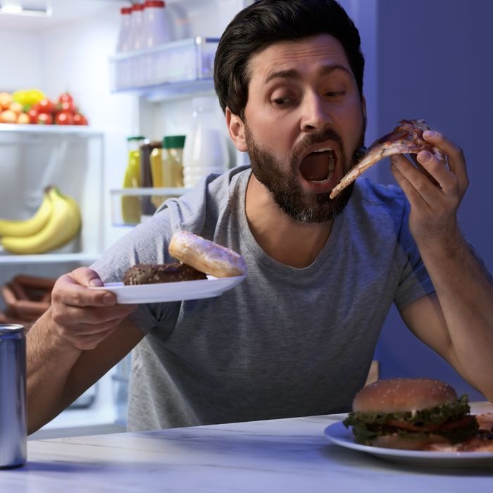 Young man eating unhealthy food