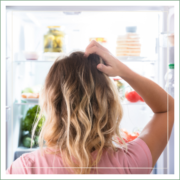 woman looking in fridge