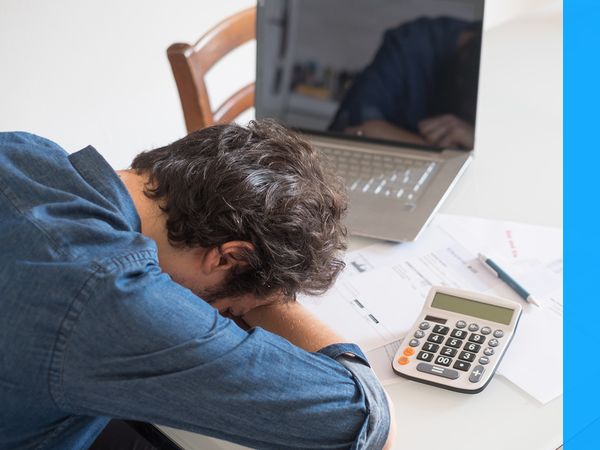 photo of man who is stressed doing taxes