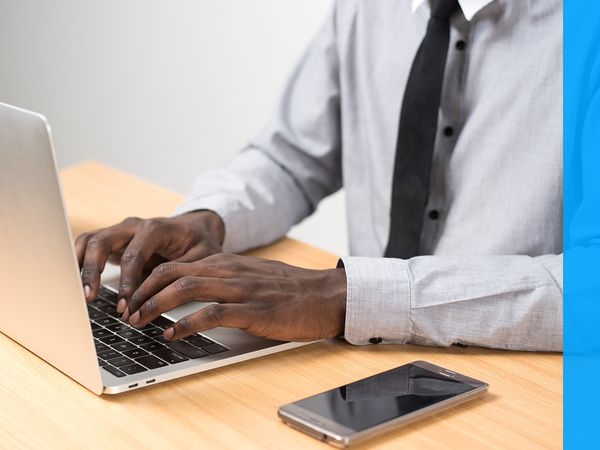 man typing on laptop keyboard