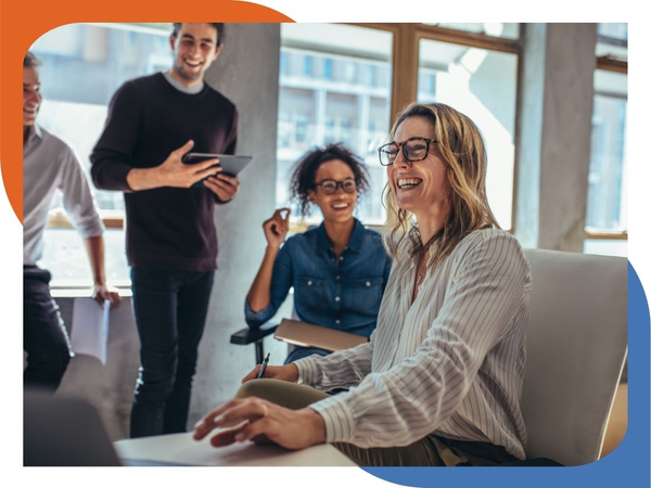 group of people smiling in work meeting