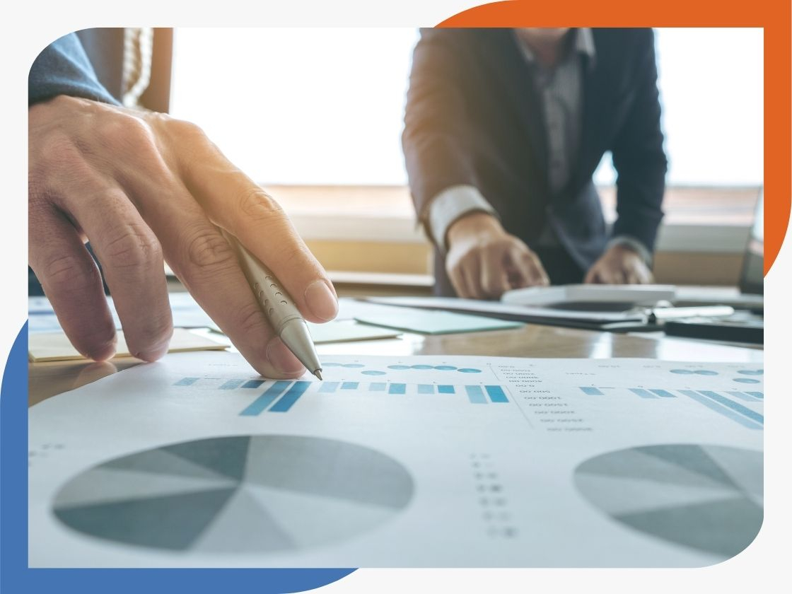 businessman pointing at data on chart