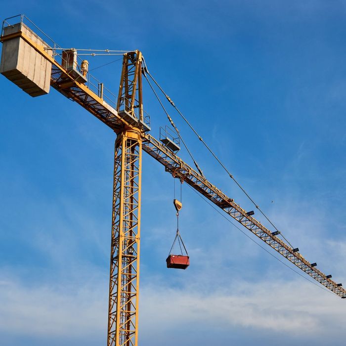 yellow crane against blue sky yellow crane against blue sky