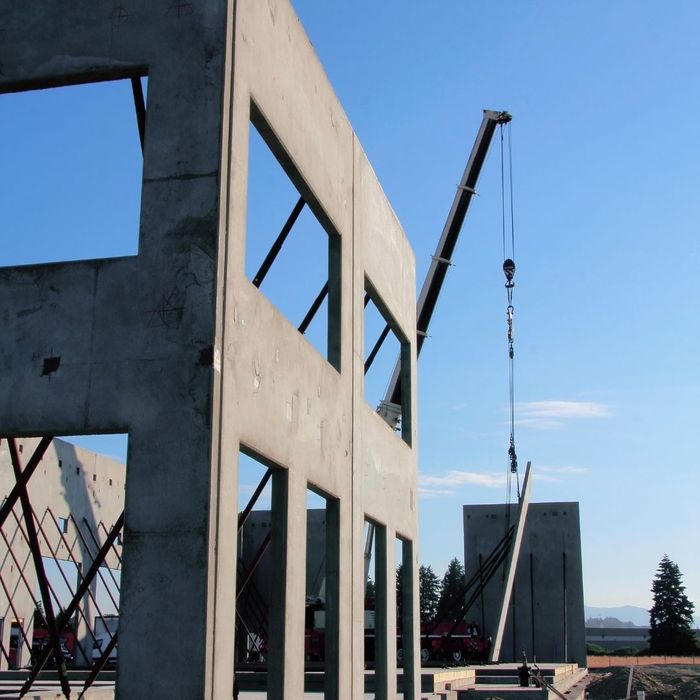 construction machine lifting materials in the middle of new construction