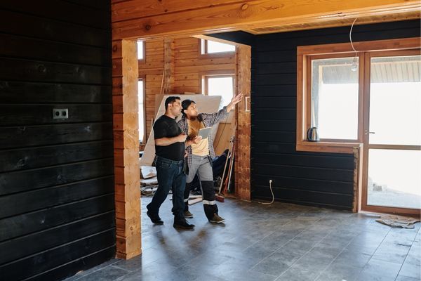 Contractors walking through a home being renovated