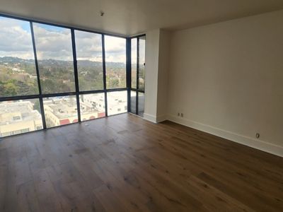 Empty apartment with wall of windows