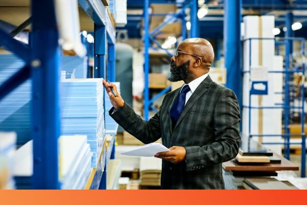 man looking at inventory in warehouse