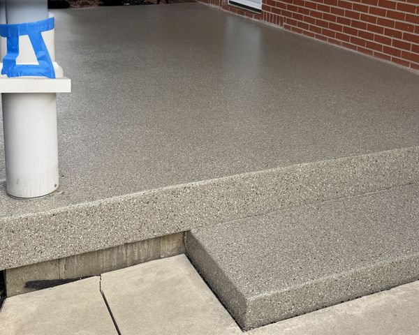 Renewed patio with polyaspartic coating in neutral Creekbed color blend, installed by Revolutionary Floor Coatings in Liberty, Indiana. Polyaspartic Coated Patio in Creekbed Blend – Liberty, IN