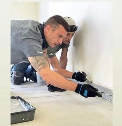 RFC Floors team members Matt and Nick installing a polyaspartic garage floor coating in Dayton, Ohio, with over 18 years of combined experience. Matt and Nick Applying Polyaspartic Floor Coating in Dayton