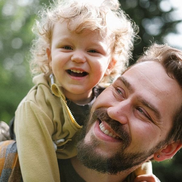 a dad caring a child on his back