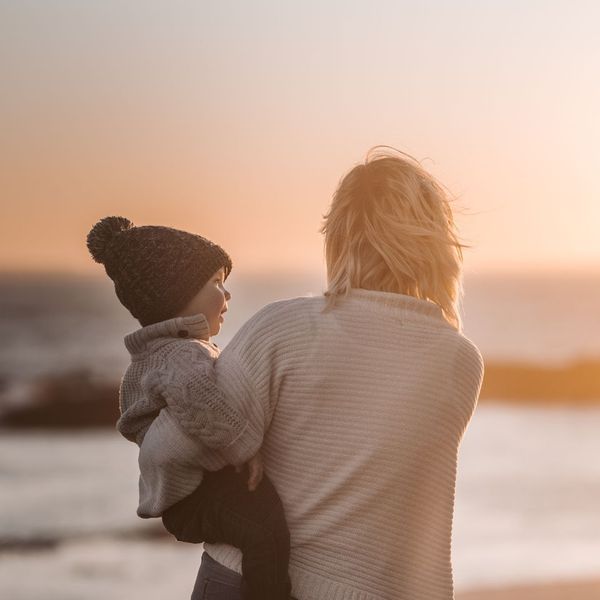 mother holding her child on the beach