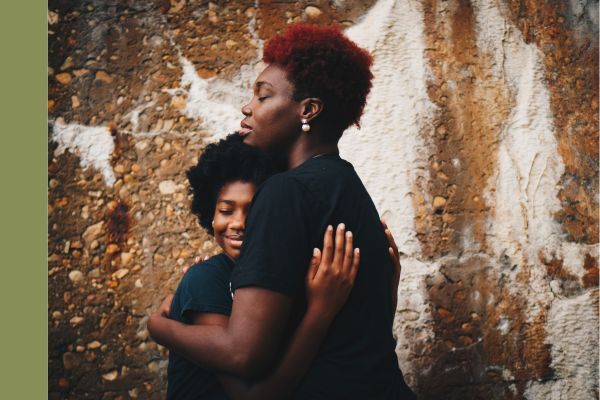 woman hugging a teenager