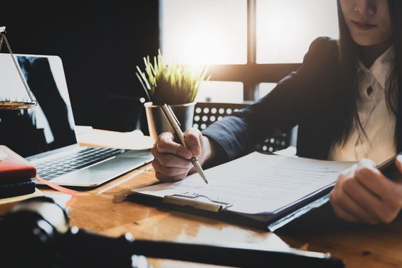 An image of a lawyer sitting at a desk.