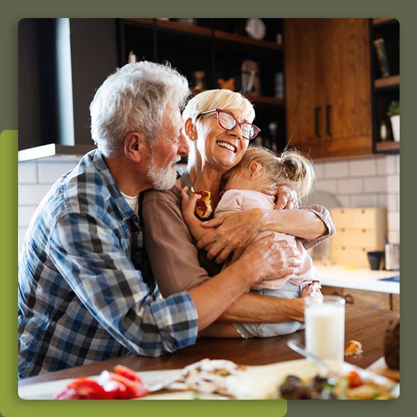 Grandparents hugging grandchild