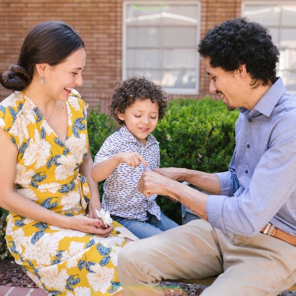 Man and woman sitting with a child