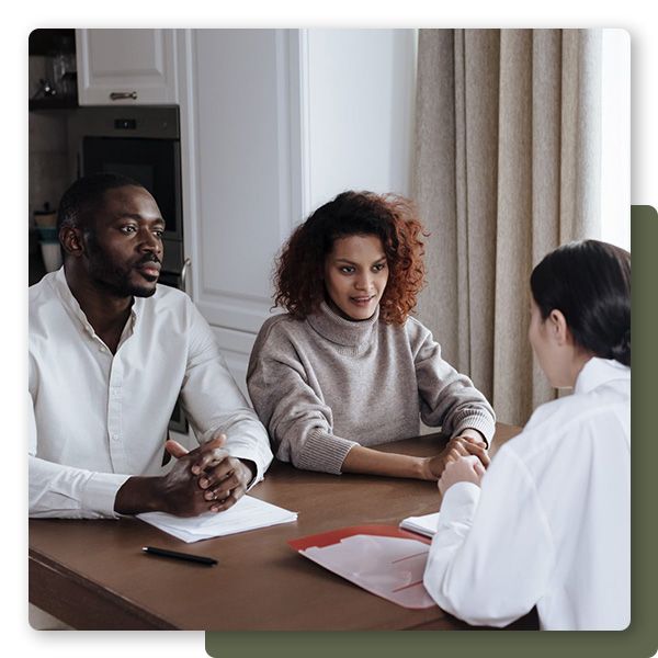 Couple talking to adoption manager