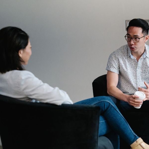 man and woman sitting down talking to each other