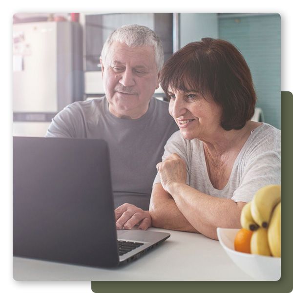 Grandparents working on computer