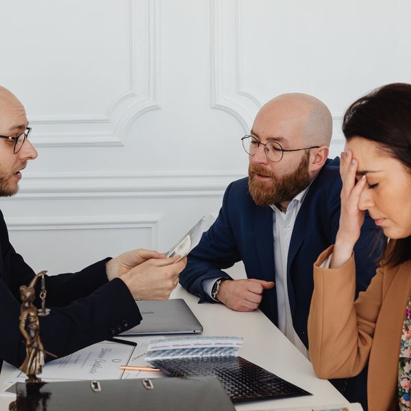 Man and woman talking with a lawyer