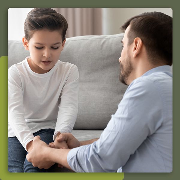 Father talking to his son on a couch