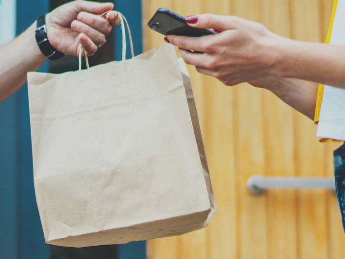 Image of a delivery person dropping off food Image of a delivery person dropping off food