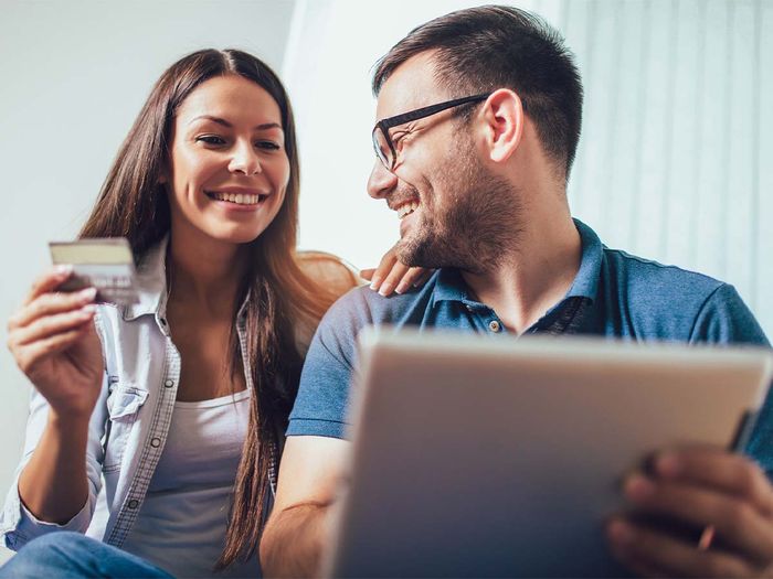 Couple ordering food online from a tablet. Couple ordering food online from a tablet.