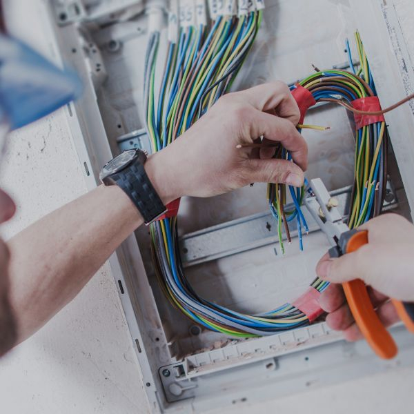 Electrician using pliers on wires