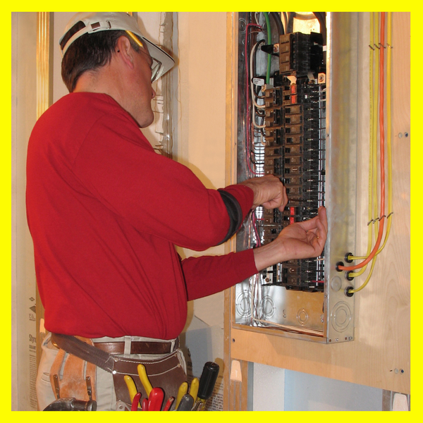 Electrician working on an electical panel