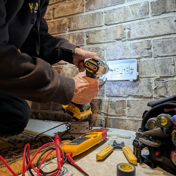Licensed electrician replacing GFCI outlet during emergency repair in Oak Ridge, North Carolina