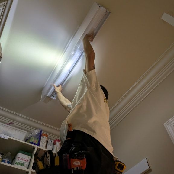 fluorescent-lighting-led-retrofit-summerfield-nc-licensed-electrician-working (1).jpg
