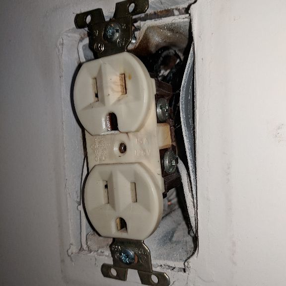 Melted electrical outlet box with internal burn damage