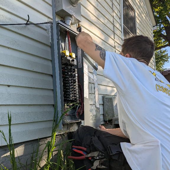 Outdoor electrical panel being diagnosed by an electrician