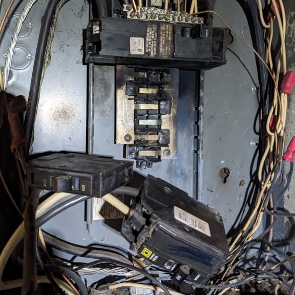 Burned residential electrical panel with severe bus bar arcing damage in Reidsville NC