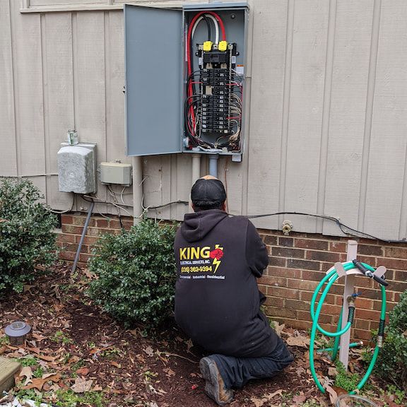 Licensed electrician performing electrical panel repair work in Summerfield, North Carolina.