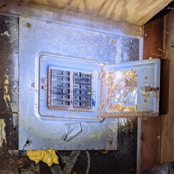 Corroded and oxidized electrical panel inspected in Pleasant Garden NC crawlspace