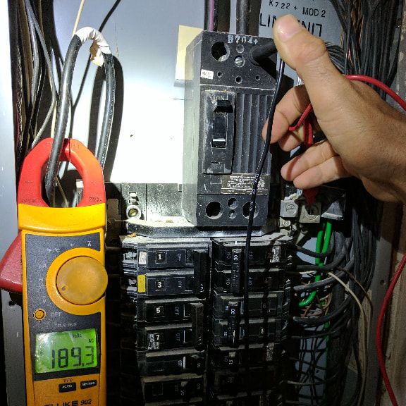 Electrician testing voltage inside an electrical panel