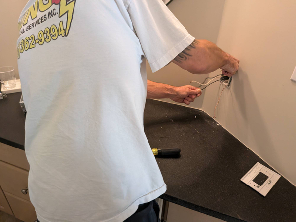 Electrician replacing burnt receptacle Greensboro NC