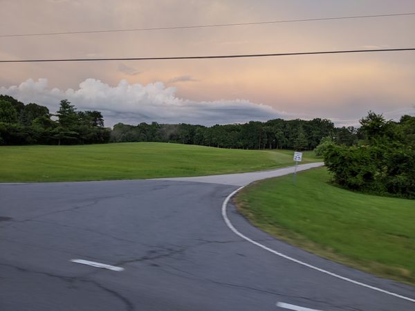 Spring storm clouds rolling in over a quiet country intersection. Surge Protector from King Electrical Services electrician