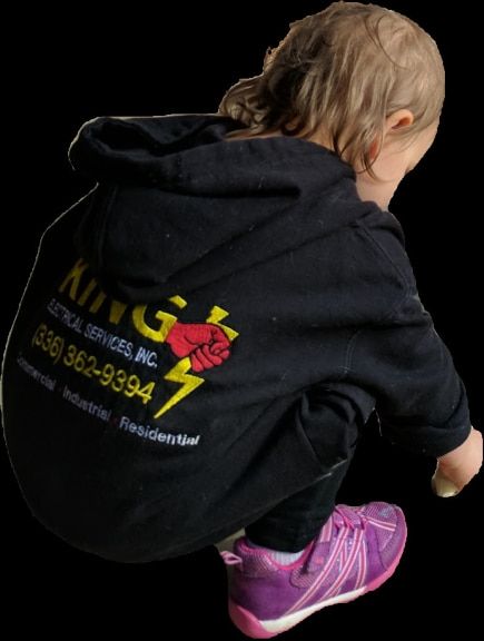 Toddler wearing a King Electrical Services hoodie shown from behind