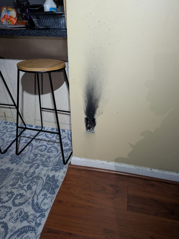 Burnt Electrical Outlet Fire Damage from Power Surge