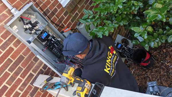 Electrician Installing Outdoor Electrical Panel in Greensboro